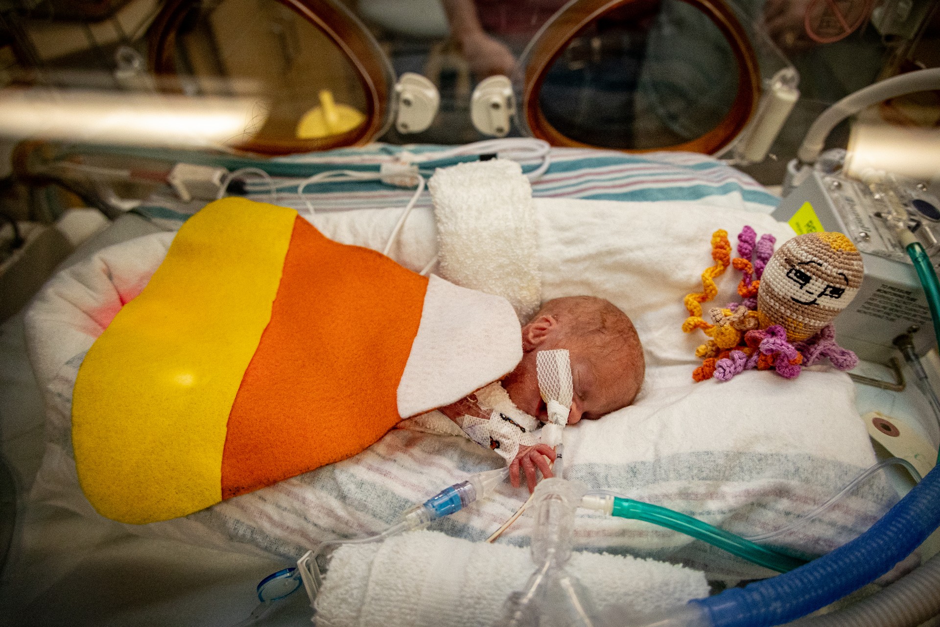 NICU baby dressed up as candy corn