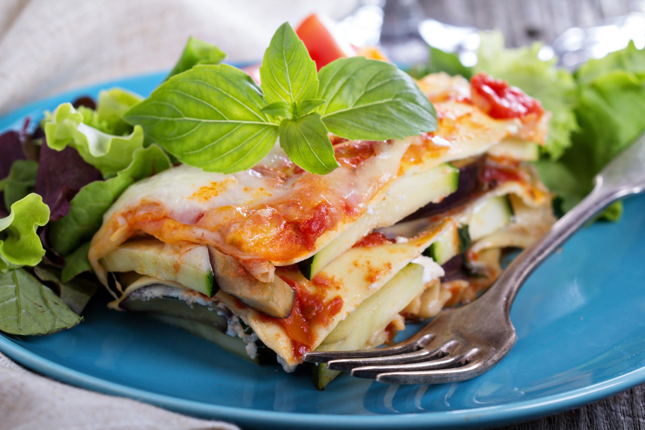 A slice of vegetable lasagna on a plate.