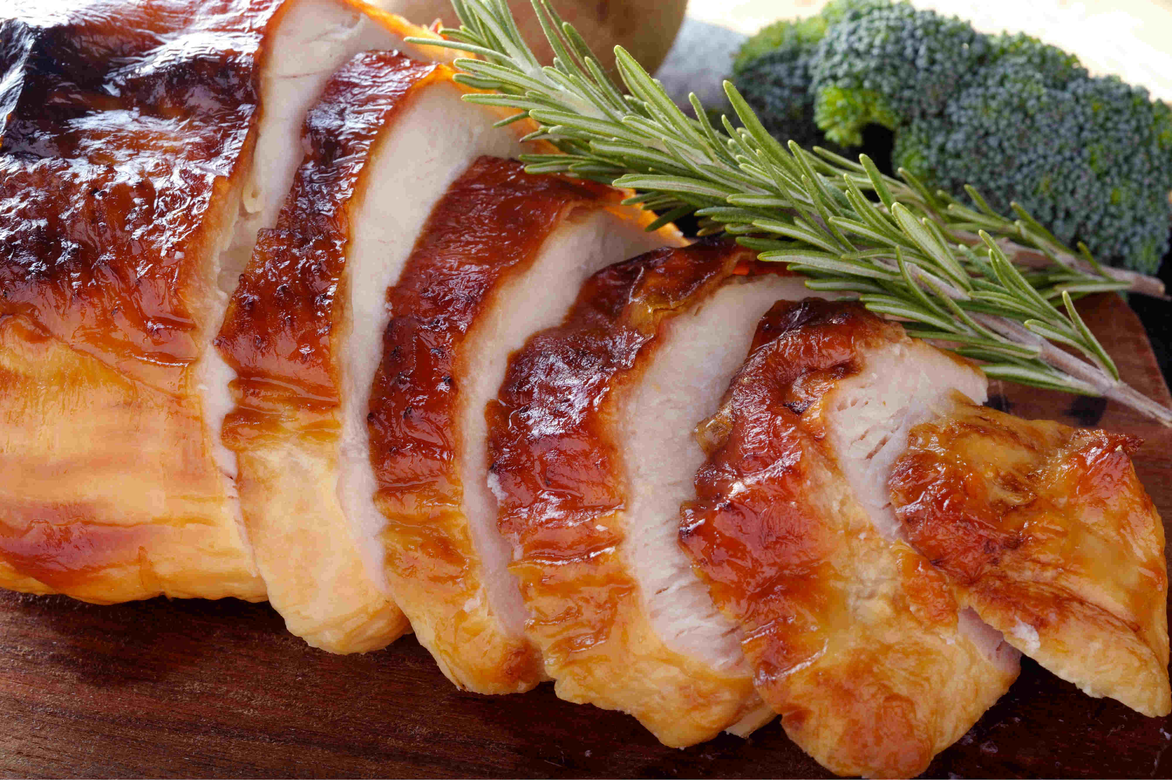 Picture of a sliced herb-roasted turkey breast.