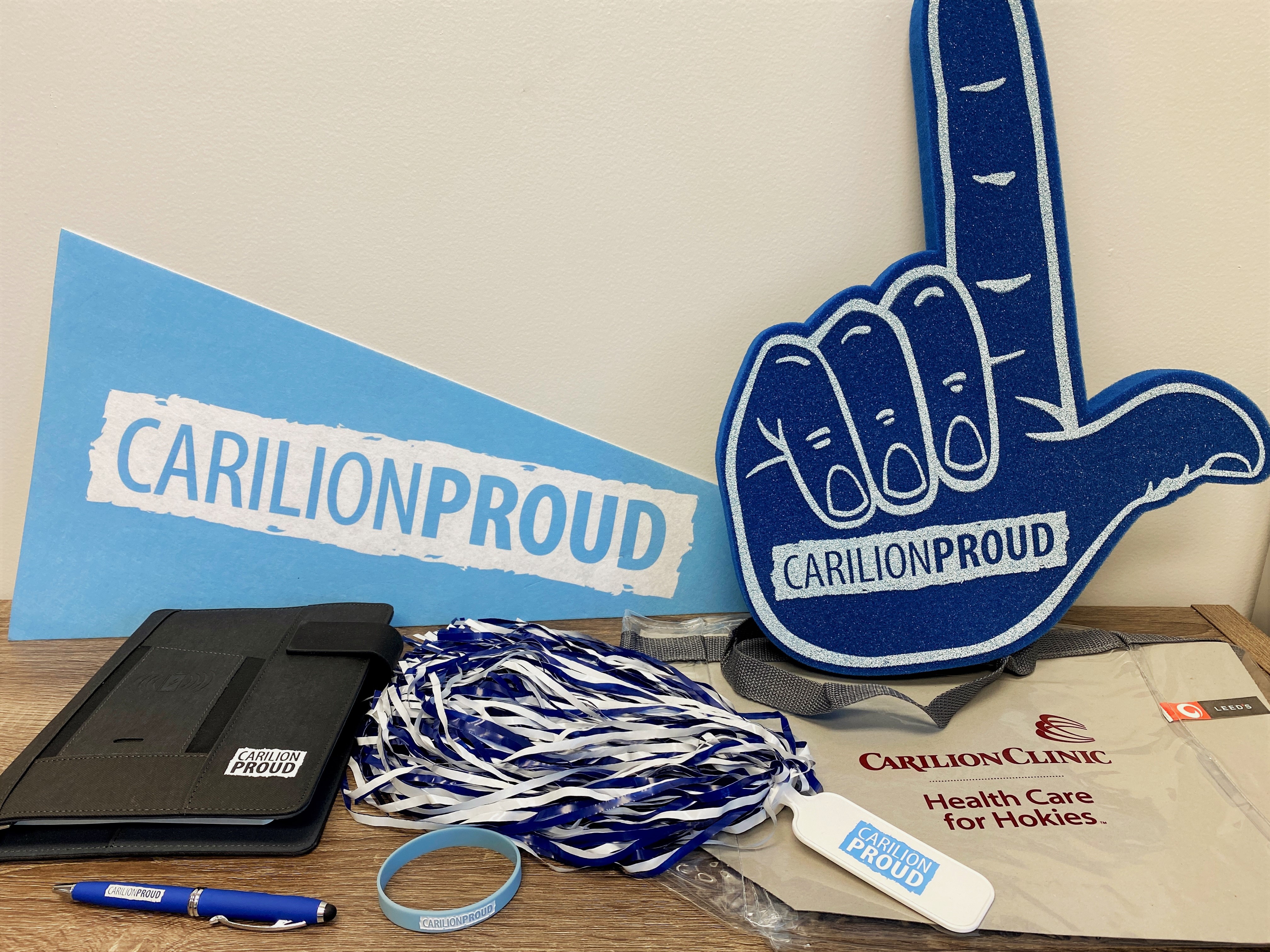 foam finger, pennant flag, bracelet, padfolio, pen, pom-pom