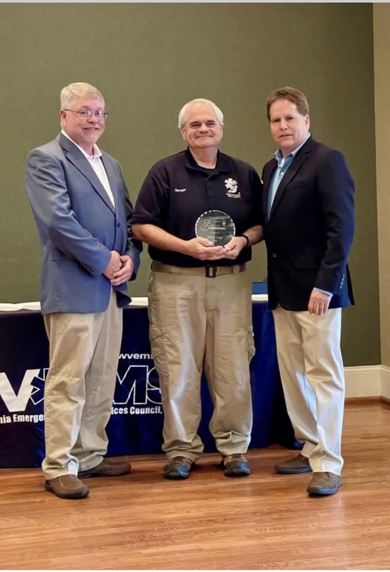 Joseph Coyle receives his award at an awards banquet.