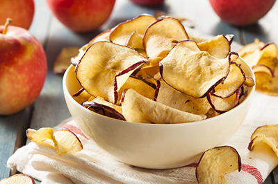 A bowl of baked apple chips.