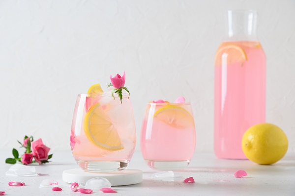 stock image of homemade pink lemonade in carafe and glasses