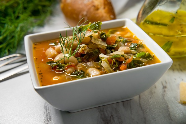 stock image of white bean tomato soup with kale