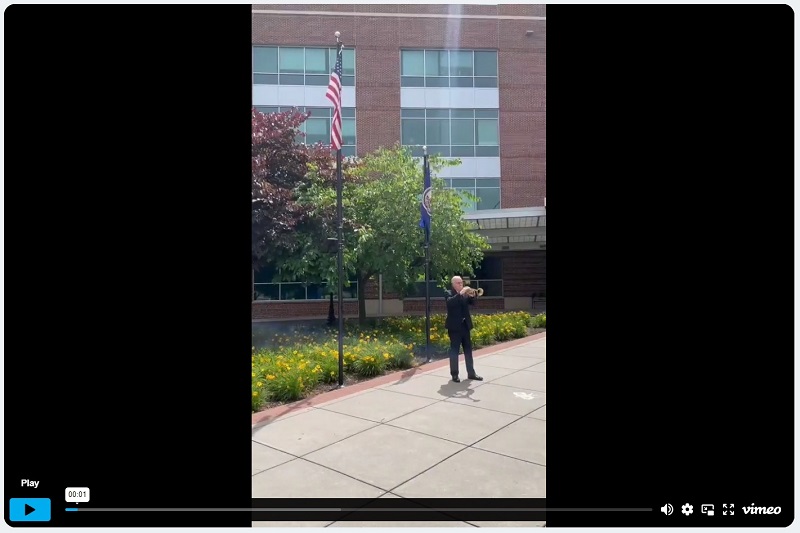 Bugler Mike Hullett plays Taps