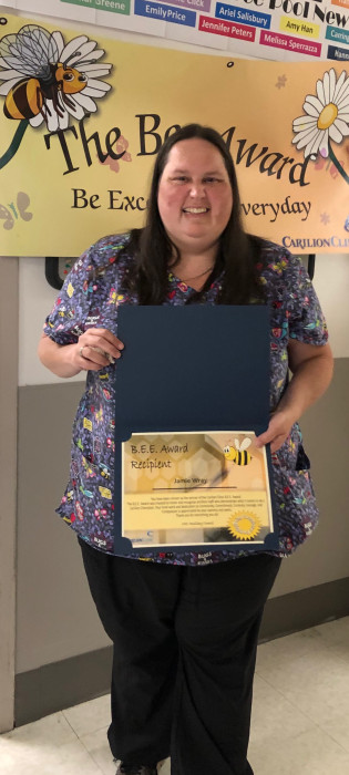 Jamie with her certificate during the Bee Award presentation.
