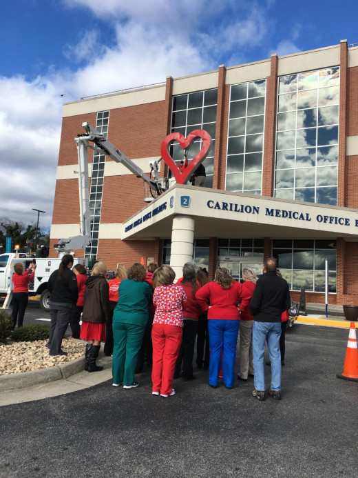 Staff watching and celebrating the heart being put into place