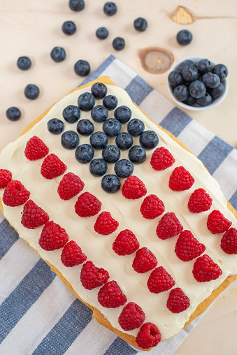 American flag cake made with raspberries and blueberries. 