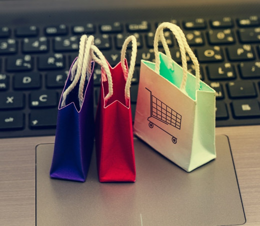 tiny shopping bags in front of a keyboard