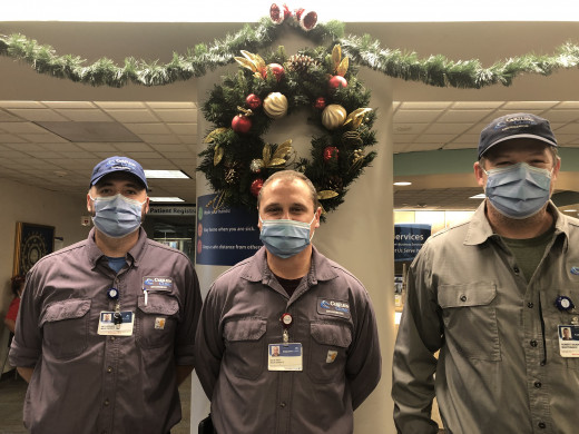 Nick Aesy (center) said "nobody appointed us" to put up decorations. It was a tradition he and co-workers Seth Spence (left) and Rob Dickinson wanted to continue. They transformed the lobby in three days.