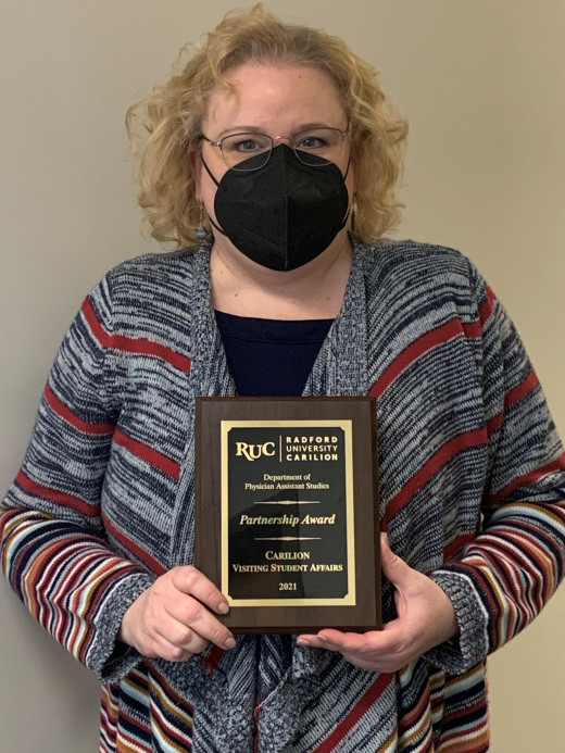 Glenda proudly displaying the community award