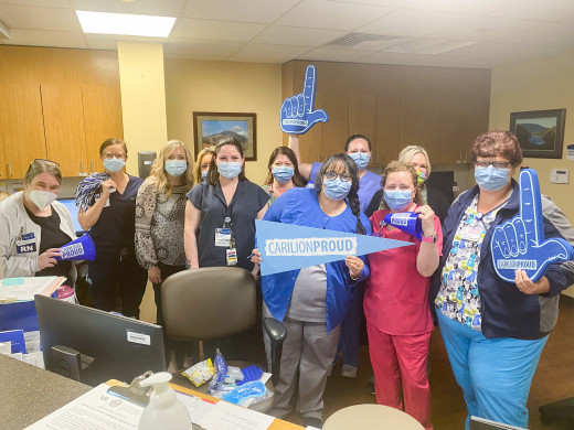 Photo of employees holding up CarilionProud signs