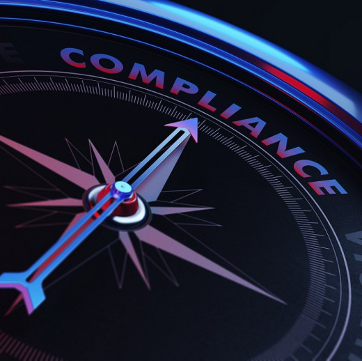 compass with arrow pointing to the word compliance