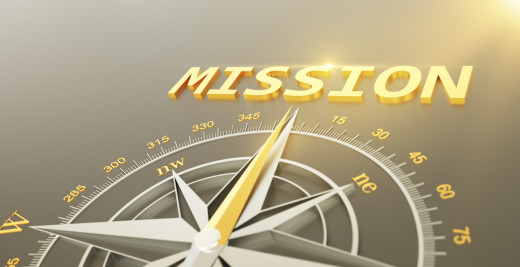 gold compass pointing to the word mission