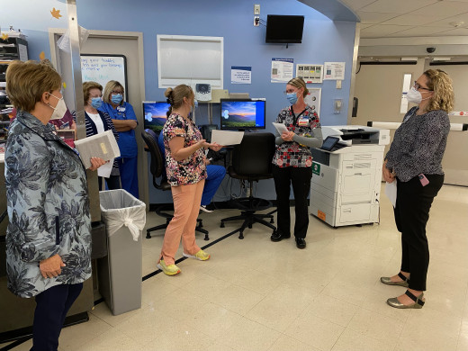 Nursing leaders presenting a clinical associate, Angela Manning, the Outstanding Preceptor Award