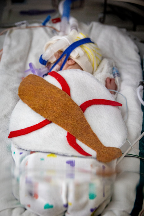 NICU patient dressed up as a baseball player for Halloween