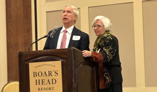 Drs. Cheri and David Hartman at the podium of the ACRP Fall Symposium discussing their ED Bridge to Treatment Program