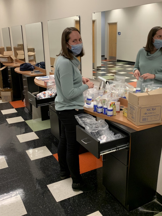Pharmacist Caitlin Swindall assembles a symptom relief pack