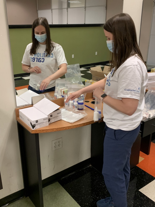 Pharmacist Lauren McDaniel assembles a symptom relief pack
