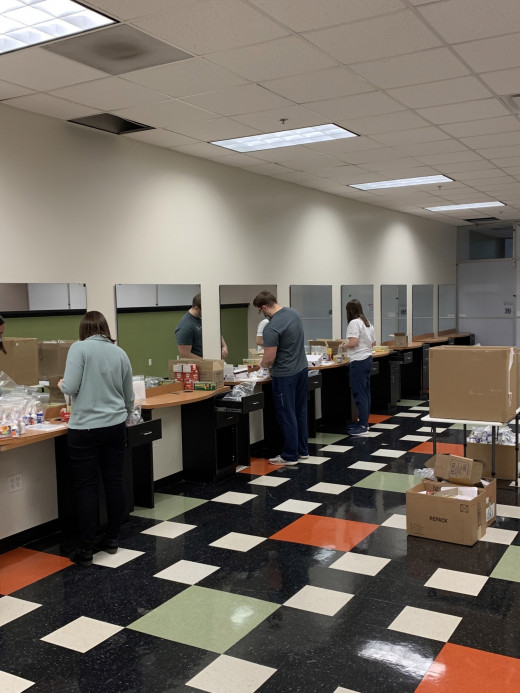 ID pharmacist team assembling symptom relief packs