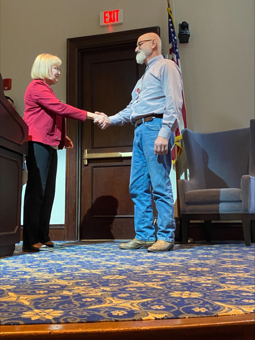 Charlie Tarasidis receiving challenge coin from Jean Bennett, SAMHSA