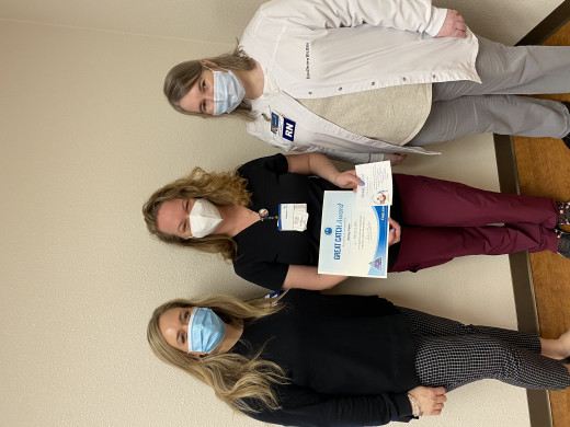 Alicia Bales and Kim Brown present  the Great Catch Award to Ashley Cates.