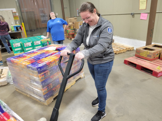 Jennifer Evans using a manual pallet trolley
