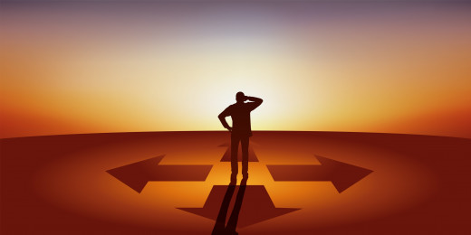person facing two arrows going in different directions