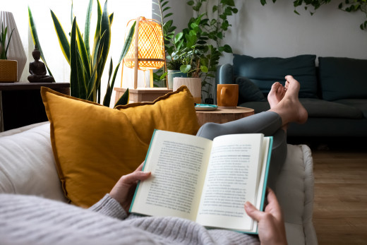 Woman reading book on couch