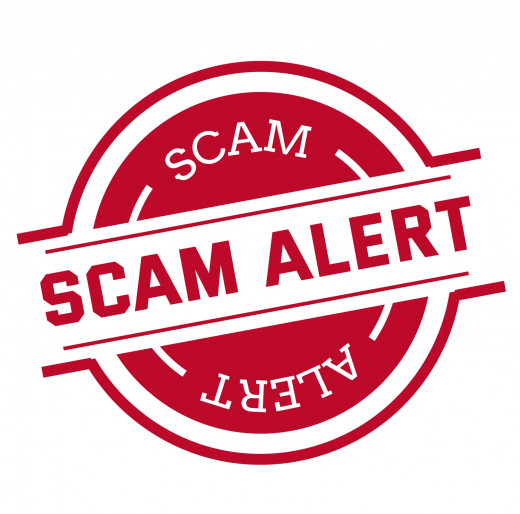 badge that says "scam alert"