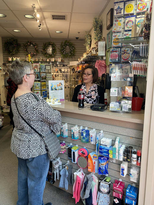 Charo Rivera helps a customer in the Gift Corner
