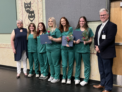 The Pinning Ceremony image presented is the 5 graduating students and instructors Cheryl Cunningham and Frank Amos.