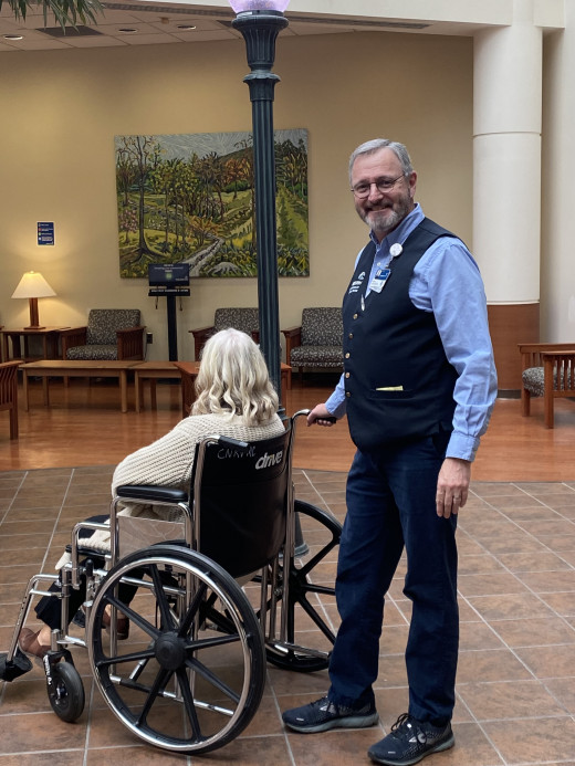 Tony Harrell offers assistance with a wheelchair