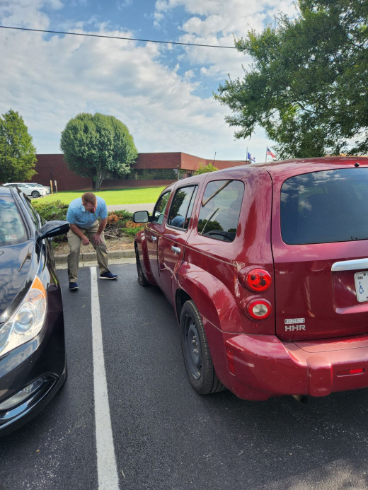 Derrick Barr going above and beyond to help change a tire for a patient 