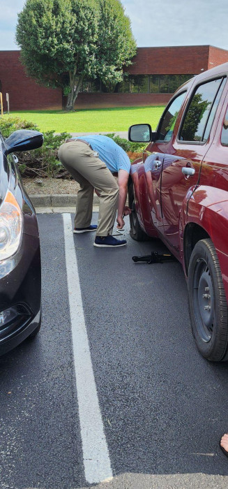 Derrick Barr going above and beyond to help change a tire for a patient 