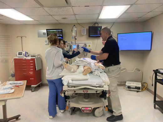 PACU Team working through the Sims scenario. Pictured: Brittany Myers PACU RN, Rachel Van Noord PACU RN, Emily Norman PACU RN, Shannon DeCourcey PACU RN, Dr. Michael Saccocci.