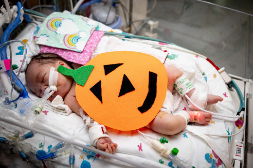 NICU patient dressed as a pumpkin
