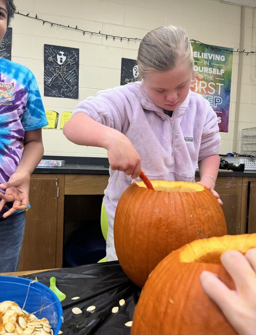 Scooping out the pumpkin. 