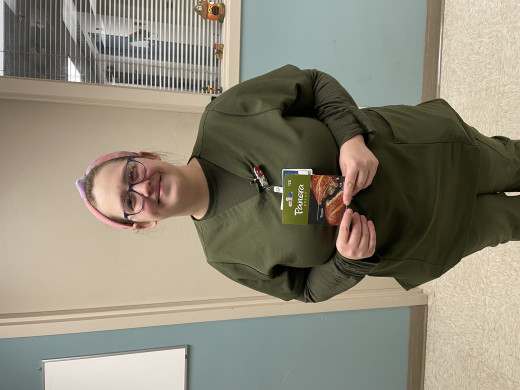 Picture of Andrea holding the gift card she won