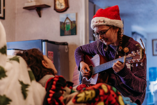 Hospice Music Therapist Jessie Palmer visits with a pediatric hospice patient