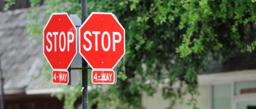 stock image of two 4-way stop signs