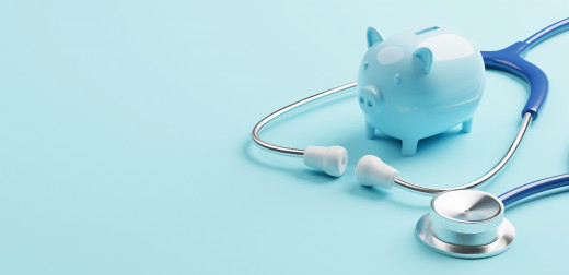 stock image of blue piggy bank with stethoscope