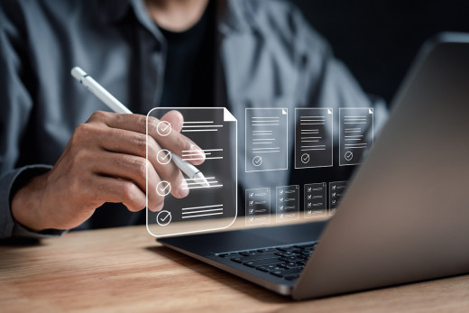 stock image of person with open laptop showing illustration of questionnaire 