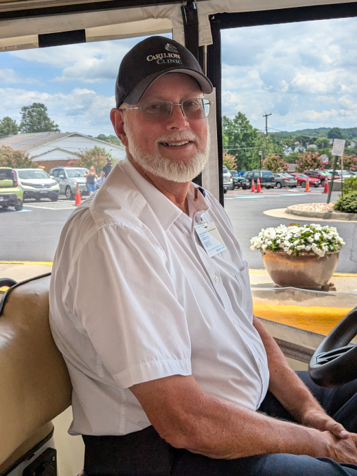 Jerry driving a golf cart