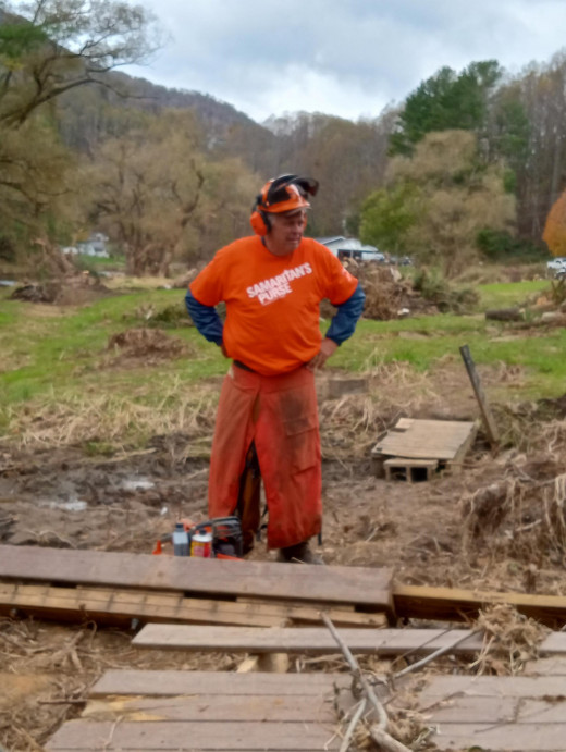 Dr Bookout taking a break from using his chainsaw  