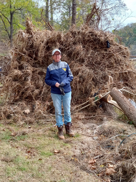 Stef Braford in front of a down tree