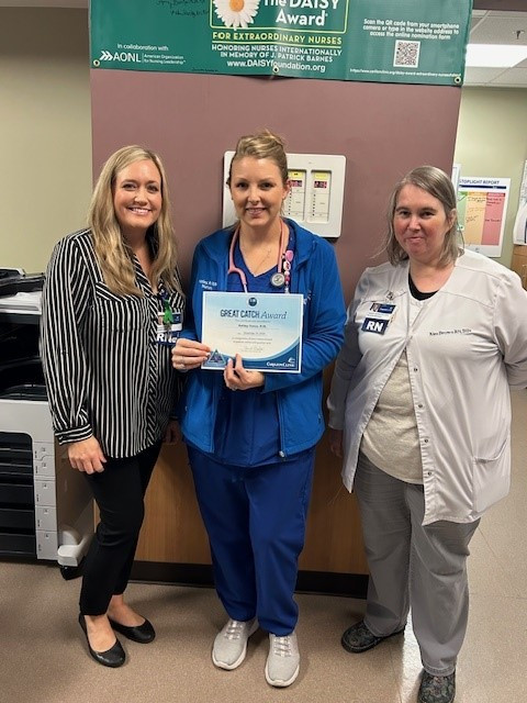 Alicia Bales, Senior Director and Kim Brown IP Manager present Ashley Vance the Great Catch Award