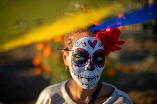 Community members in traditional face paint