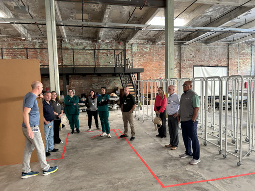 Supply Chain and Sim Lab staff discussing a supply room layout. 