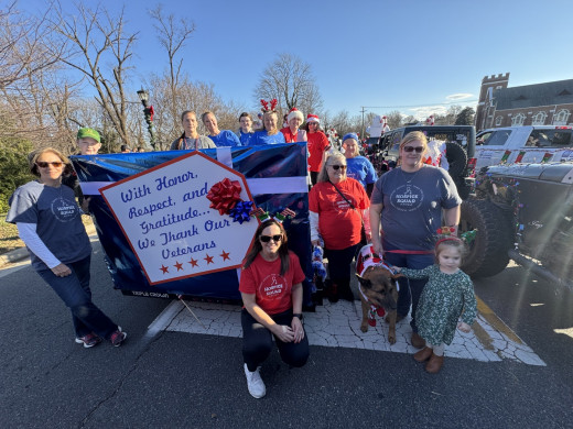 Carilion Franklin Hospice parade team posing by float.